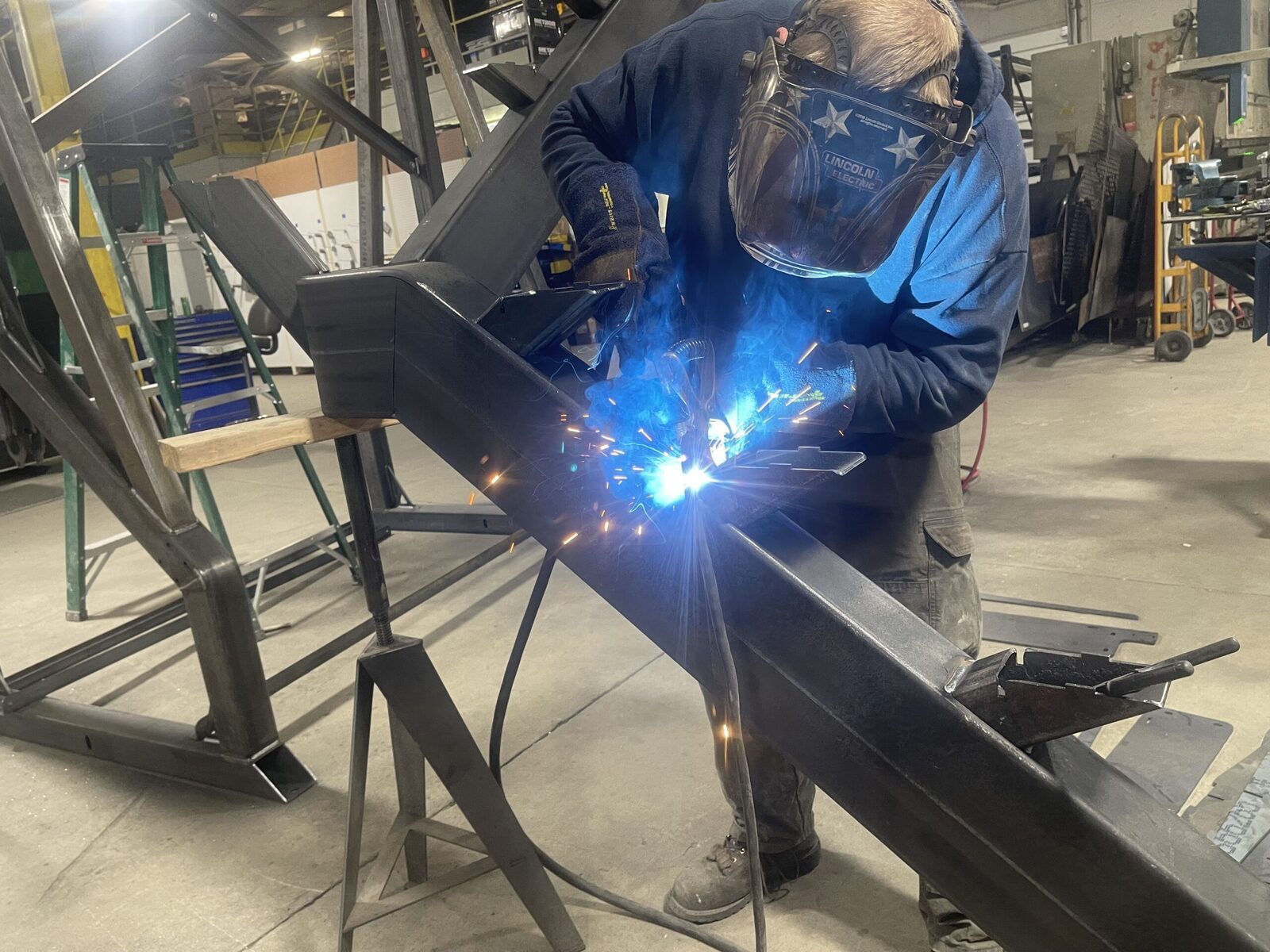 Interior of The High Road Manufacturing facility showing welding stations and fabrication workspace in Ponderay, Idaho