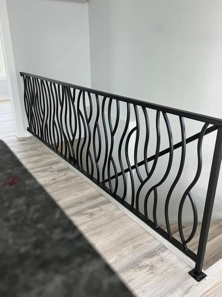 Custom welded metal handrail with unique design pattern manufactured by The High Road in North Idaho