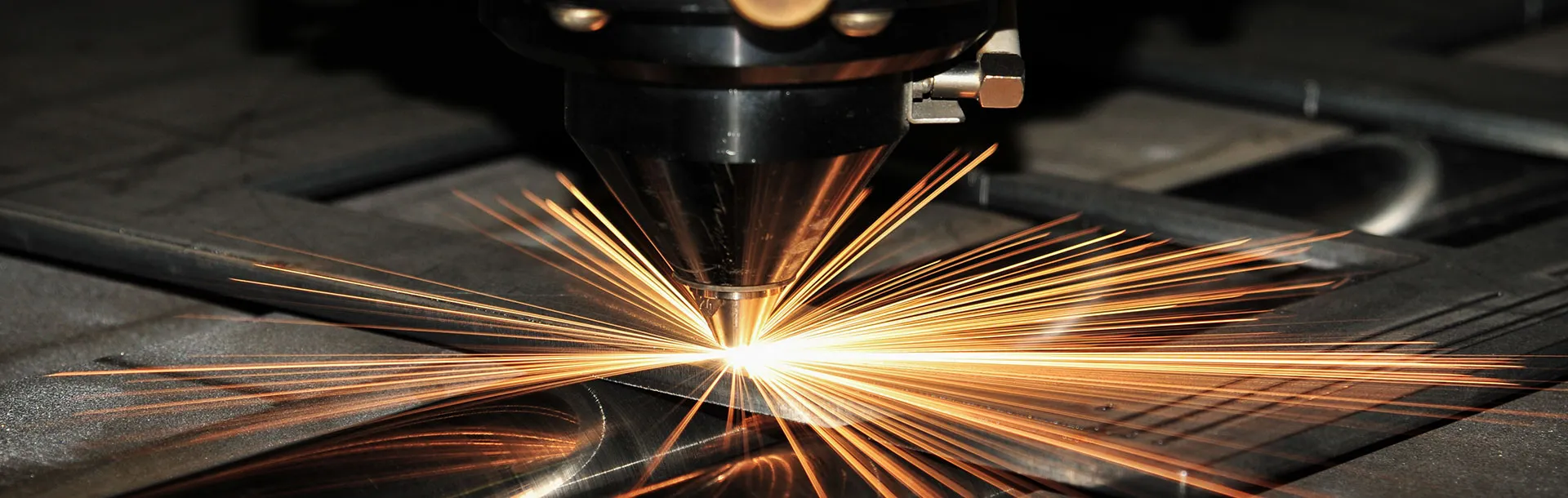 CNC fiber laser cutting system producing precision steel parts at The High Road Manufacturing