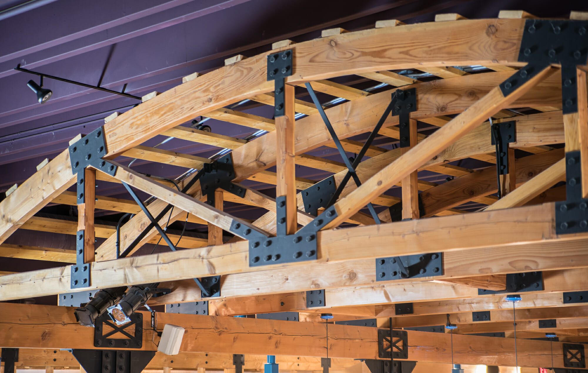 Heavy timber and structural steel frame connection with custom truss brackets fabricated by The High Road Manufacturing